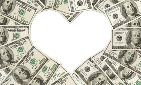 One hundred dollar bills in the shape of a heart isolated on white background The love of money