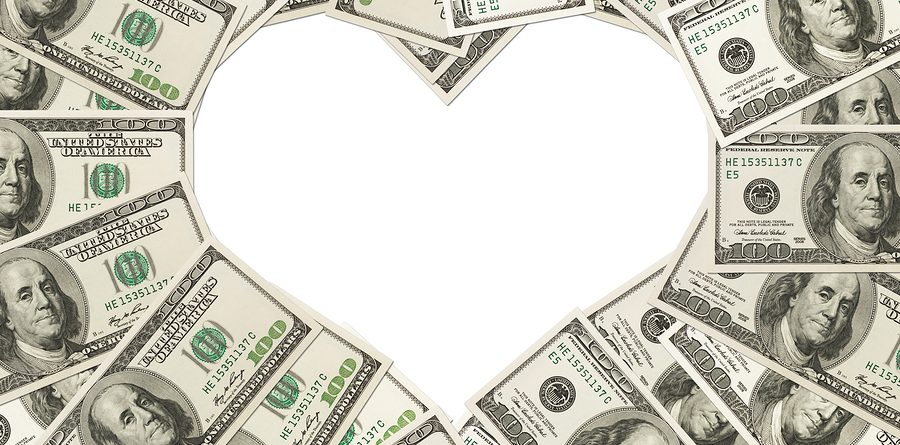 One hundred dollar bills in the shape of a heart isolated on white background The love of money