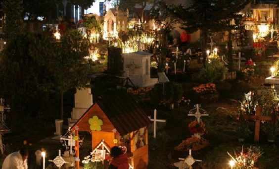 Candles light up graves in the San Gregorio cemetery during Day of the Dead celebrations in Mexico City, early Sunday, Nov. 1, 2009. According to tradition, candles are lit to guide wandering souls back to their families. (AP Photo/ Marco Ugarte)