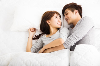 happy young lovely couple lying in a bed
