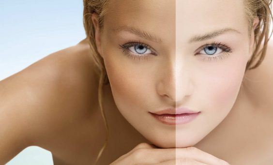 Beauty visual about suntan. Model's face divided in two parts - tanned and blanc.