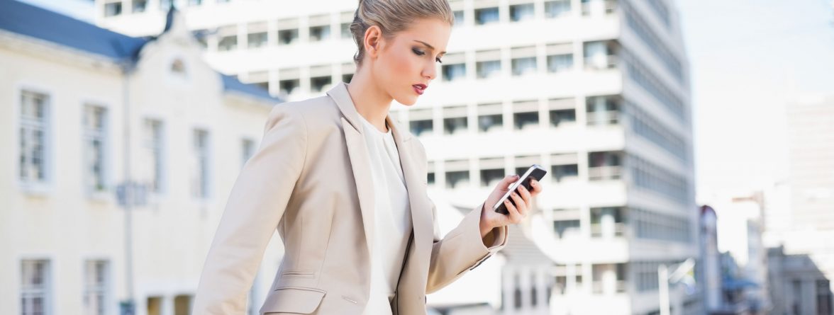 businesswoman-walking-with-smartphone-web
